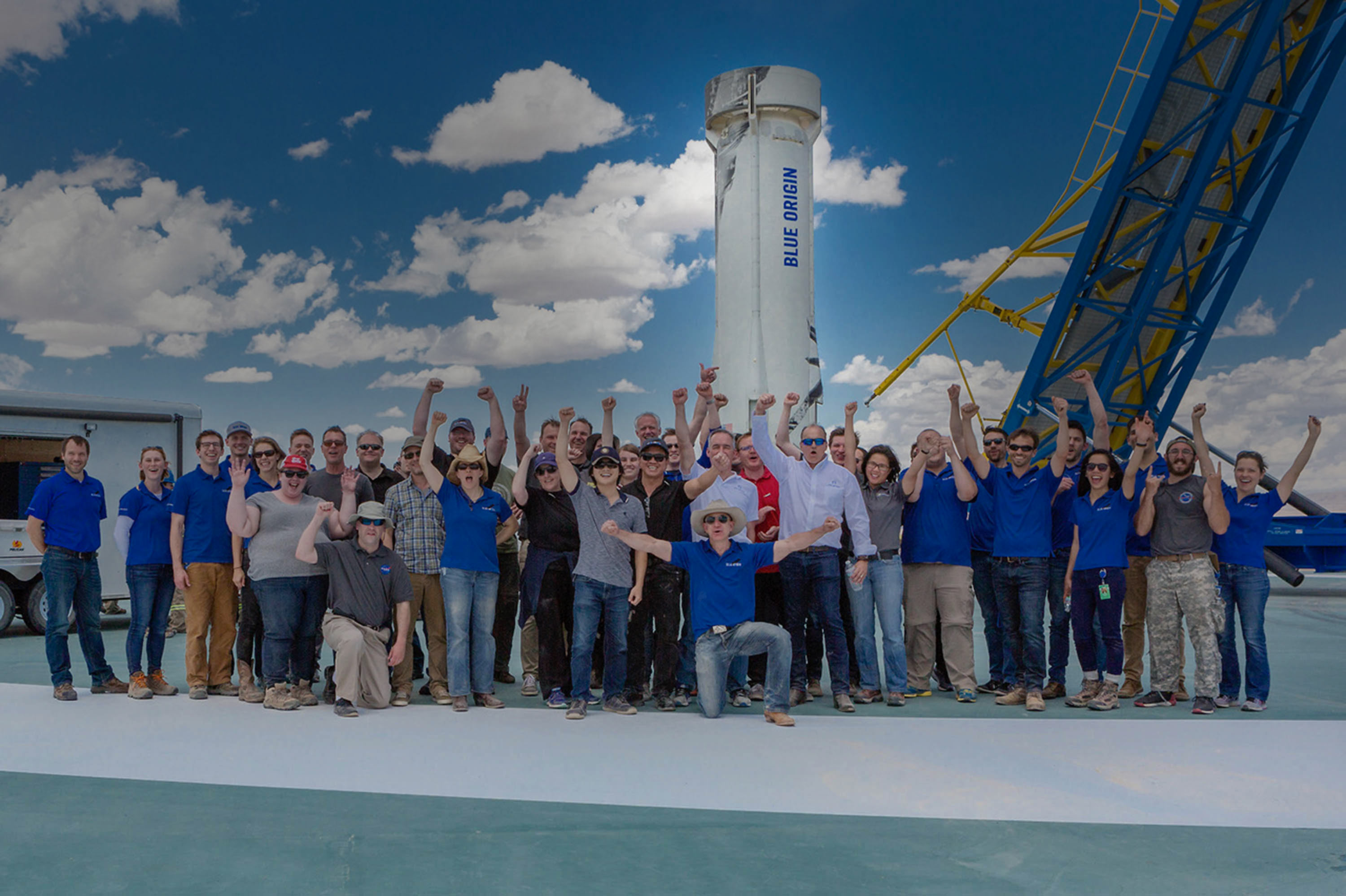 Blue Origin employees celebrate on the landing pad in front of New Shepard following its historic first landing in 2015.